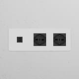 Paintable black power module with 2 Schuko/Bipasso sockets and triple USB 30W, ideal for home or office use.