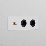 Triple toggle switch with 2 Swiss Type J power modules in paintable antique brass black on a white wall.