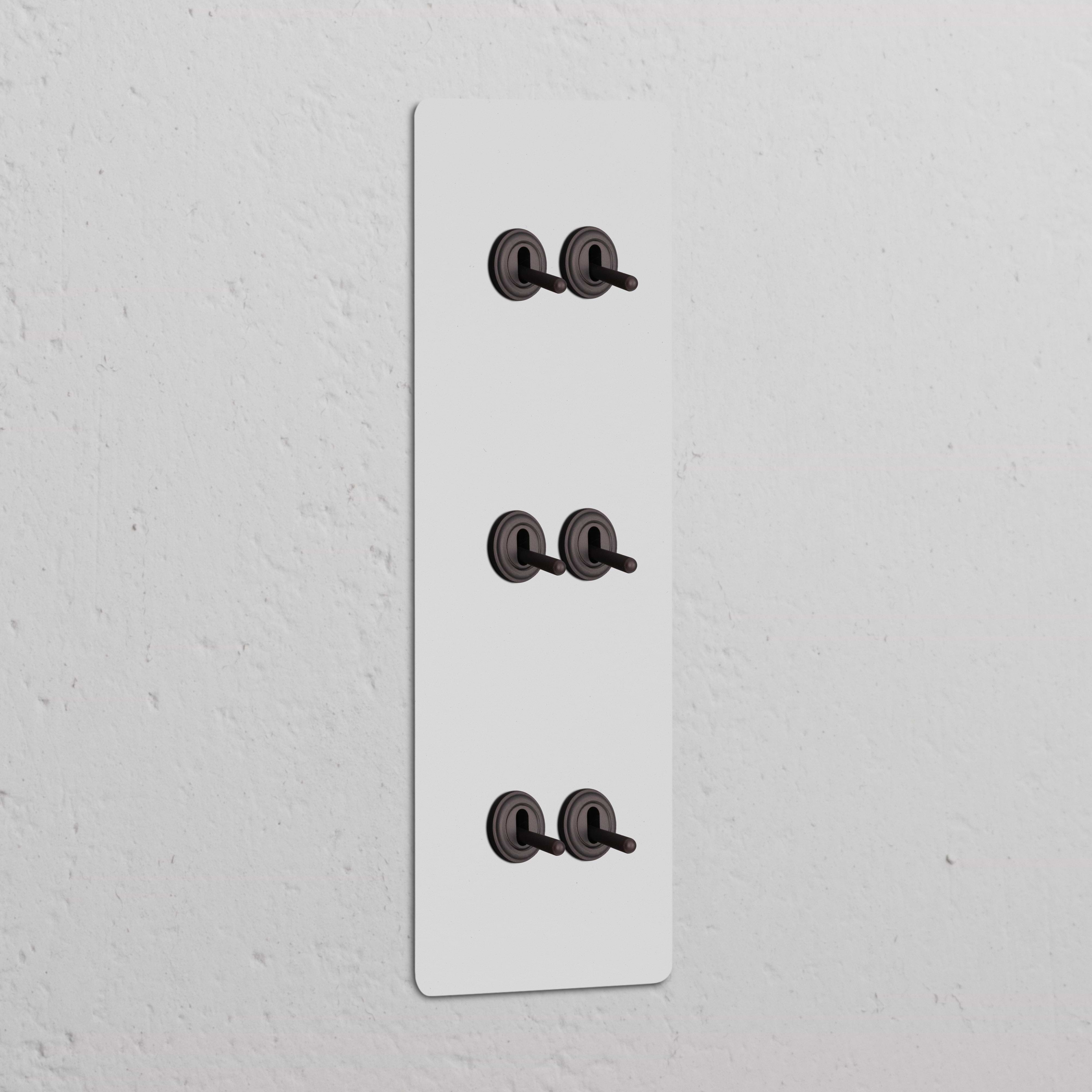 Triple 6x Vertical Toggle Switch in Paintable Bronze, part of Triple Vertical Switches & Dimmers collection.