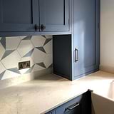 Bronze Kilburn Furniture Knob on Blue Kitchen Cabinets