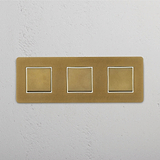 Smooth Operation with Triple Rocker Switch in Antique Brass White Design on White Background
