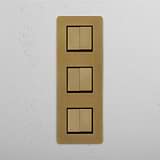Six Position Triple Vertical Rocker Switch in Antique Brass Black on White Background