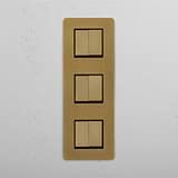 Six Position Triple Vertical Rocker Switch in Antique Brass Black on White Background