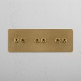 Antique Brass Triple Toggle Switch Designed with Six Levers on White Background