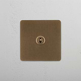 Central Antique Brass Single Toggle Switch, Functional and Stylish on White Background