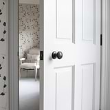 Bronze Poplar Sprung Knob on White Wooden Door
