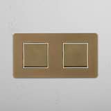 Two Position Double Rocker Switch in Antique Brass White on White Background
