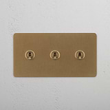 Elegant Double Toggle Switch in Antique Brass finish on White Background