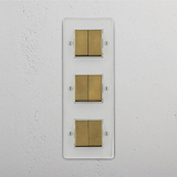 Superior Light Management Solution: Vertical Six-Position Triple Rocker Switch in Clear Antique Brass White on White Background