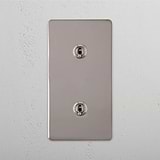 Dual Vertical Light Toggle Switch on White Background: Polished Nickel Double 2x Vertical Toggle Switch