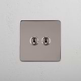 Dual Control Light Toggle Switch on White Background: Polished Nickel Single 2x Toggle Switch