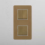 Four Position Vertical Double Rocker Switch in Antique Brass White on White Background