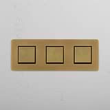 Antique Brass Black Triple Rocker Switch with Three Switching Positions on White Background