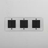 Modern Six-Position Triple Rocker Switch in Clear Bronze Black for Light Control on White Background