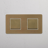 Two Position Double Rocker Switch in Antique Brass White on White Background