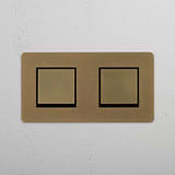 Stylish Double Rocker Switch in Antique Brass Black finish on White Background