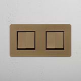 Antique Brass Black Double Rocker Switch, Four-Switch Design on White Background