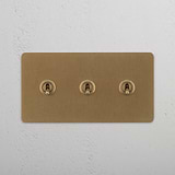 Elegant Double Toggle Switch in Antique Brass finish on White Background