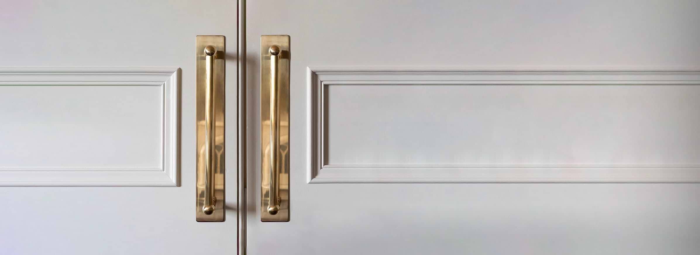 elegant antique brass door handle on white door