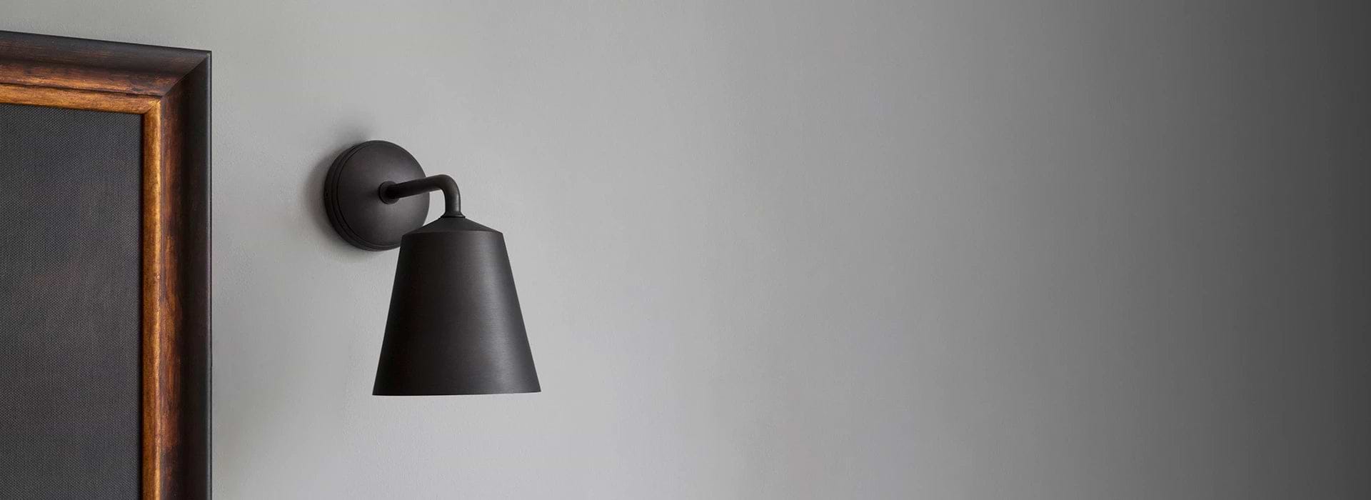 Bronze wall light by Corston on grey Background