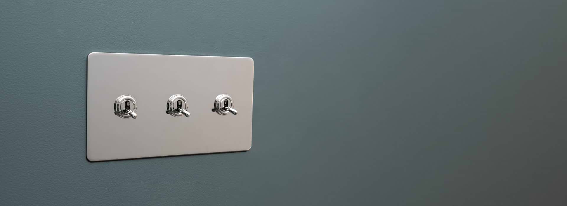 3 Toggle polished nickel switch by Corston on Grey background