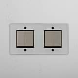 Abrangente interruptor basculante duplo de quatro posições em Níquel Polido Transparente Preto para gestão de luz em fundo branco