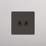 Interruptor articulado duplo em Bronze com 2 botões em fundo branco