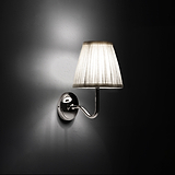Small Malvern Wall Light in Alabaster White at an angle and turned on at night