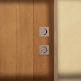 Wooden door with two square metal locks and a polished nickel Regent Recessed Small Pull below.