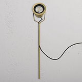 Cambridge Ground Floodlight – Antique Brass outdoor floodlight with circular head, shown on a white surface.