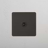 Bronze Switch Against Wallpapered Wall With Wooden Chair