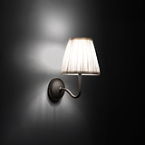 Small Malvern Wall Light in Alabaster White at an angle and turned on at night