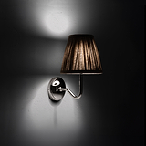 Small Malvern Wall Light in Natural Beige at an angle and turned on at night