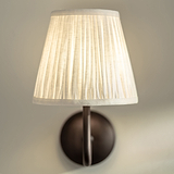 Small Malvern Wall Light in Alabaster White front facing close up of pleated shade and turned on