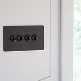Bronze 4G two way toggle switch fixed to white wall