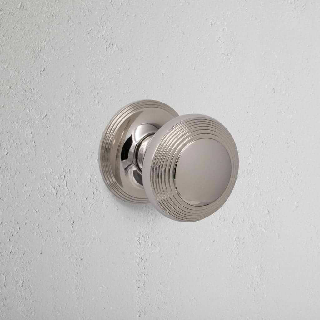 Polished Nickel Poplar Fixed Door Knob On White Background