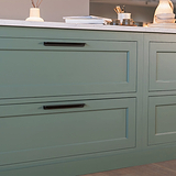 Bronze Oxford Furniture Handle 384mm fitted to an undercounter kitchen unit draw. Displaying green draws with white marble.