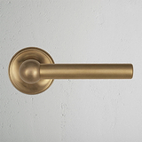 Antique Brass Harper Sprung Door Handle On White Background
