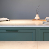 Bronze Oxford Furniture Handle 384mm fitted to an undercounter kitchen unit draw. Front on view showing two handles on two green draws with white stone coutner top.