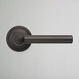 Bronze Harper Sprung Door Handle On White Background