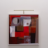 Abstract painting in red, brown, gray shapes, framed on a white wall, lit by Harrow Antique Brass light.