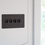 Bronze 4G two way toggle switch fixed to white wall