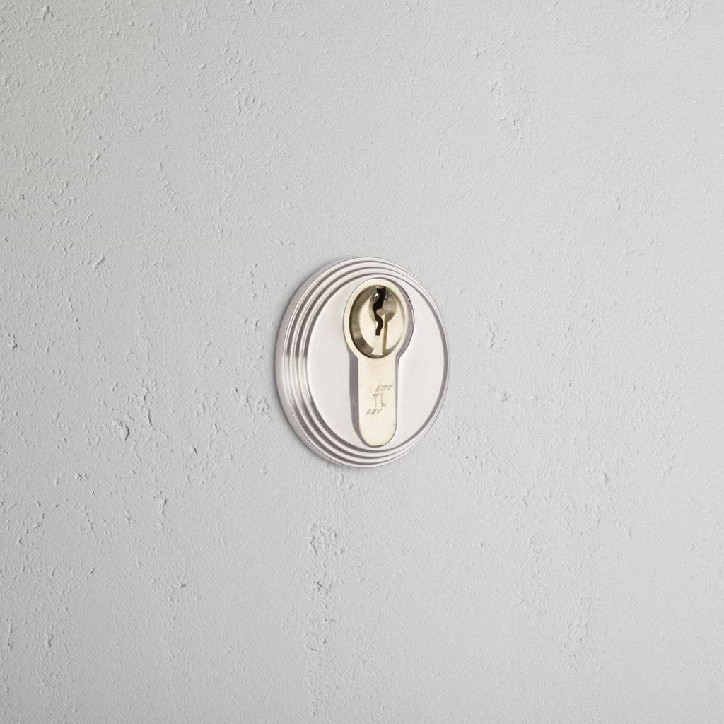 Polished Nickel Warwick Key Escutcheon On White Background