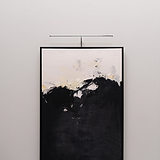 Abstract painting with light brushstrokes on a black base, framed in black and lit by a Harrow Picture Light.