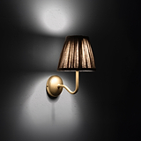 Small Malvern Wall Light in Natural Beige at an angle and turned on at night