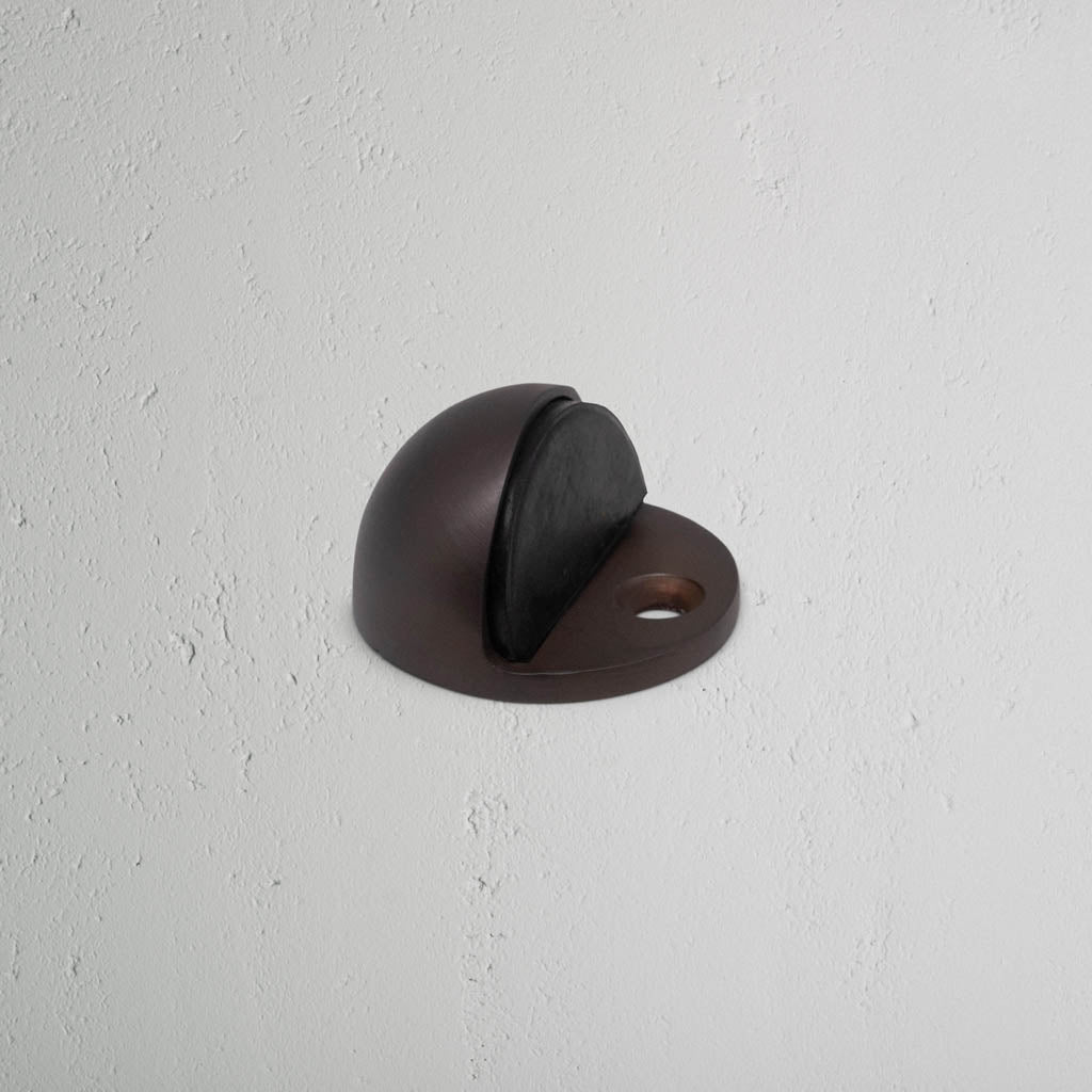 Bronze Half Moon Door Stop On White Background