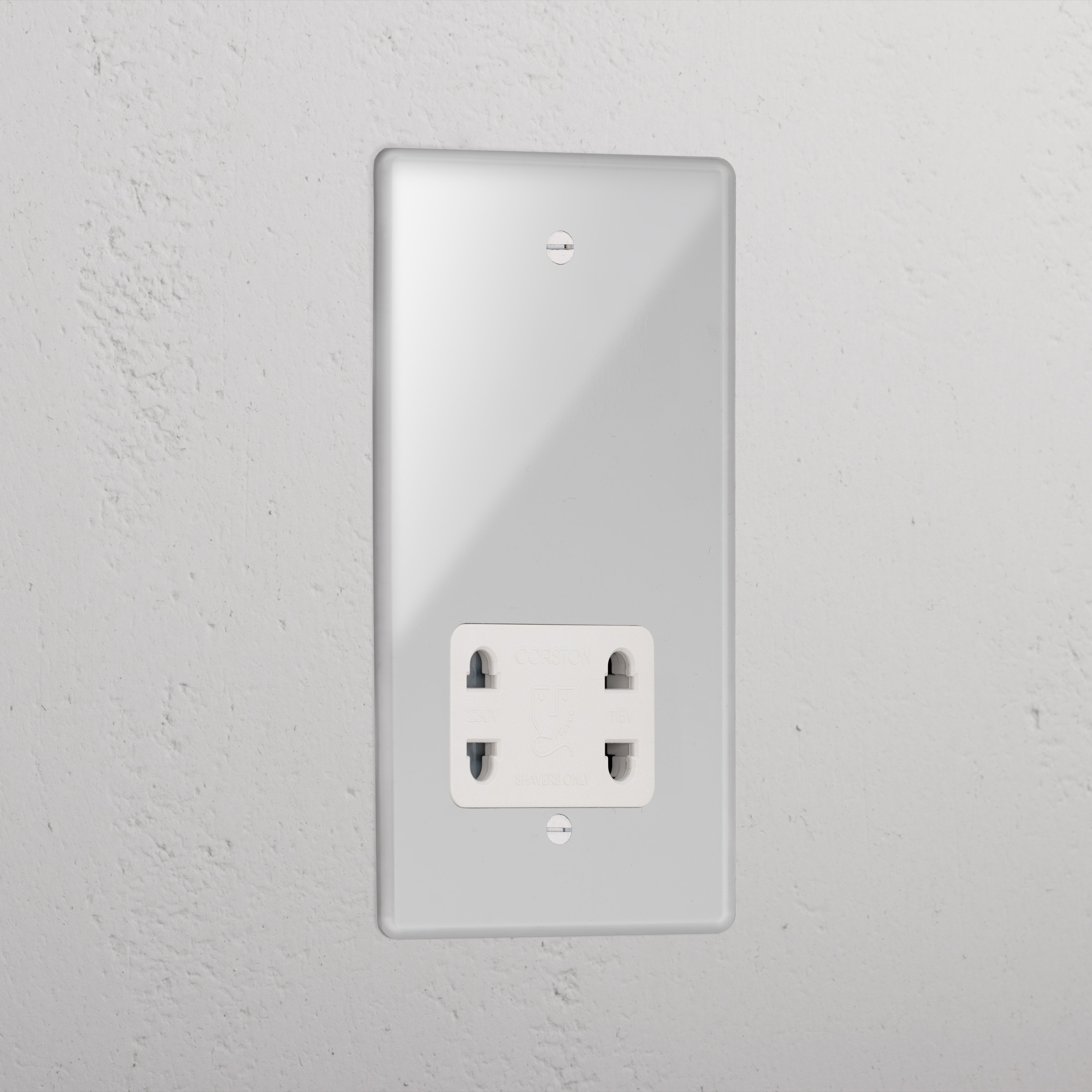 Transparent shaver socket with white insert on grey wall. 