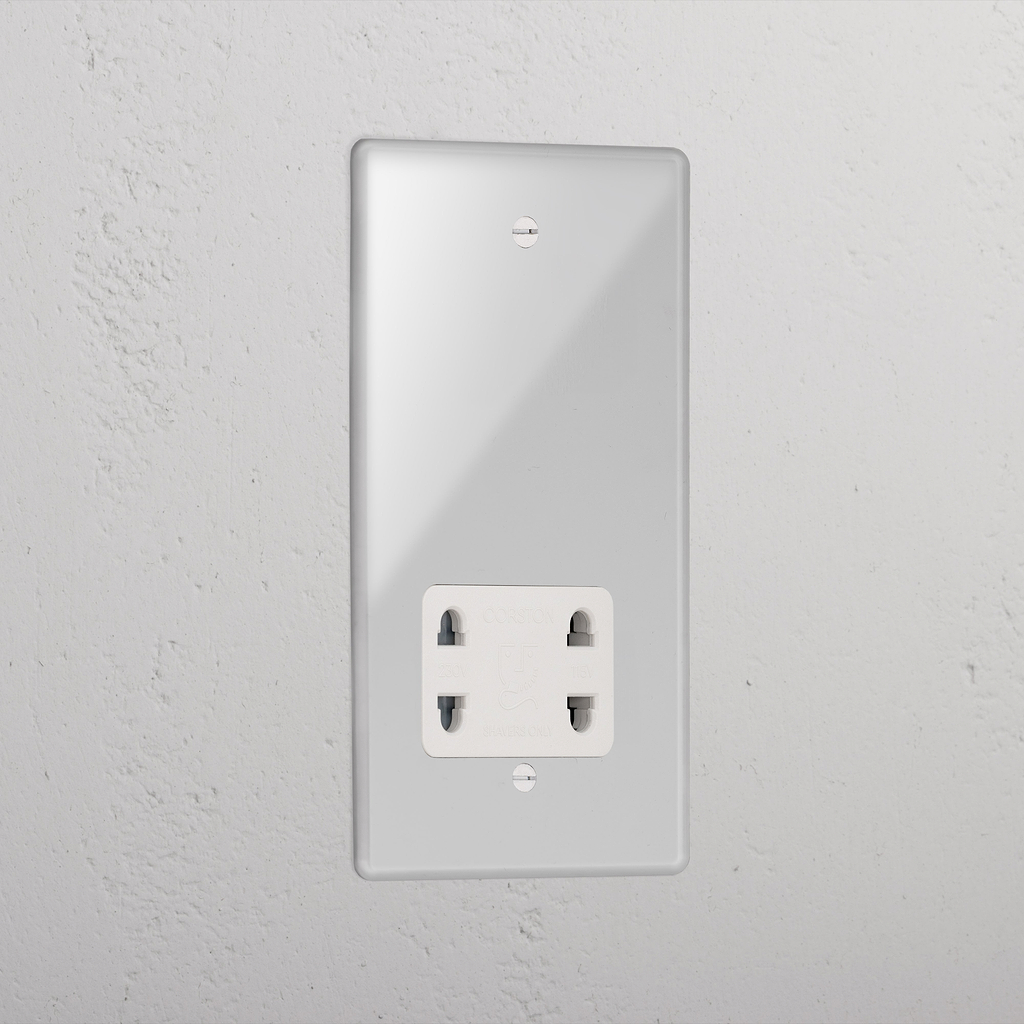 Transparent shaver socket with white insert on grey wall. 