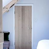 Clear Toggle Light Switch On White Wall With Wooden Door