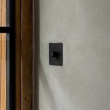 Bronze Dimmer Switch On Cream Wall With Wooden Window Frame